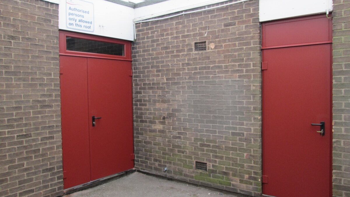 Certified red fire doorsets installed in a commercial building
