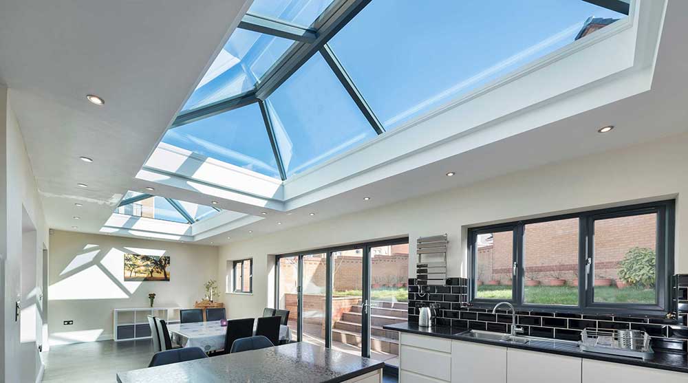A flat-roof rooflight letting daylight into a modern room below